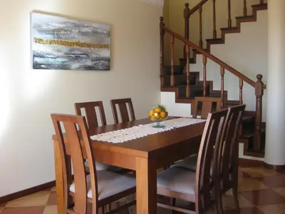 a dining room with a wooden table and chairs at Casa Maresia- Sea view & Private pool in Ponta do Sol