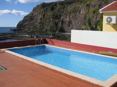 a swimming pool with a view of the ocean at Casa Maresia- Sea view & Private pool in Ponta do Sol