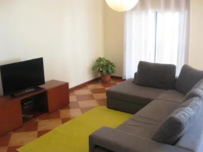 a living room with a couch and a flat screen tv at Casa Maresia- Sea view & Private pool in Ponta do Sol
