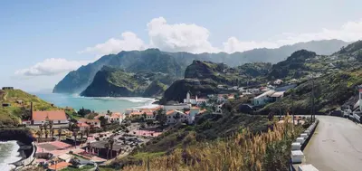 a small town on a hill next to the ocean at Ohana Madeira Guest House in Porto da Cruz