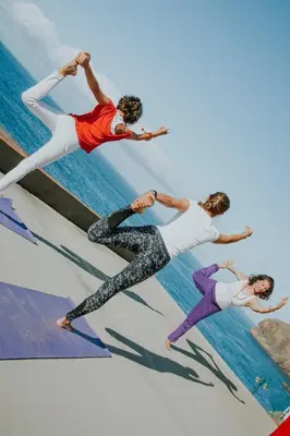 a group of people standing on a ledge near the water at Ohana Madeira Guest House in Porto da Cruz