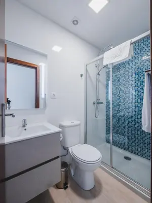 a bathroom with a toilet and a sink and a shower at Ohana Madeira Guest House in Porto da Cruz