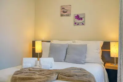 a bedroom with a large bed with two lamps at Vilamar- Madeira Inn Group in Calheta