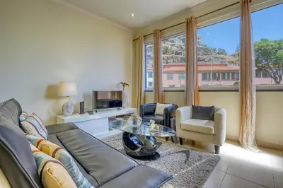 a living room with a couch and a table at Vilamar- Madeira Inn Group in Calheta