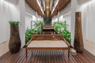a bench sitting on a wooden floor in a building at Belmar Spa & Beach Resort in Lagos