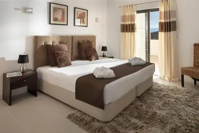 a bedroom with a large white bed and a window at Belmar Spa & Beach Resort in Lagos