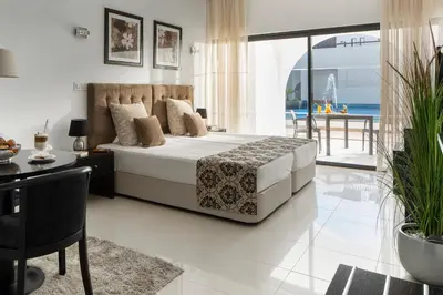 a bedroom with a bed and a view of the ocean at Belmar Spa & Beach Resort in Lagos