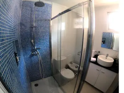 a bathroom with a shower with a toilet and a sink at ParadisMare in Machico