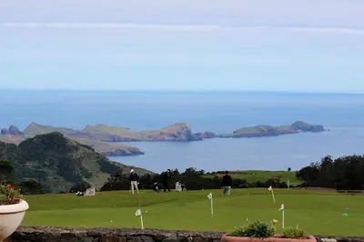 a golf course with a view of the ocean at ParadisMare in Machico