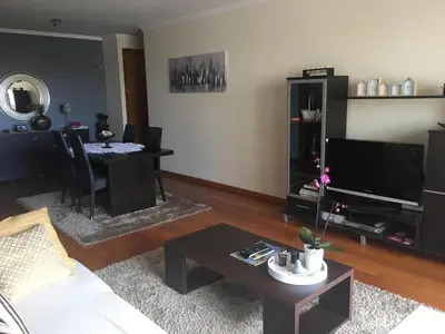 a living room with a couch and a table at Atlantis Apartment in Câmara de Lobos