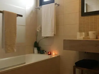 a bathroom with a bath tub and a candle at Atlantis Apartment in Câmara de Lobos