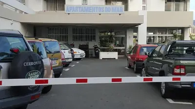 a parking lot with cars parked in front of a building at Apartamento VISTA MAR in Funchal
