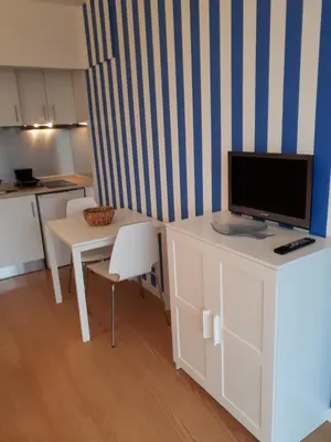 a living room with a tv on a white desk at Apartamento VISTA MAR in Funchal