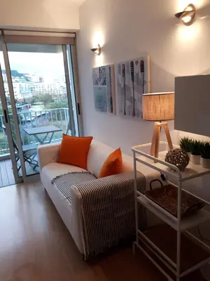 a living room with a couch and a table with a lamp at Apartamento VISTA MAR in Funchal