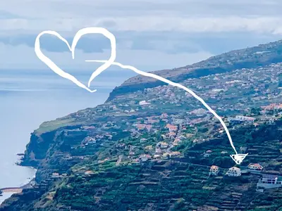 a heart shaped kite flying over a mountain at Casa Serena Apartments in Arco da Calheta
