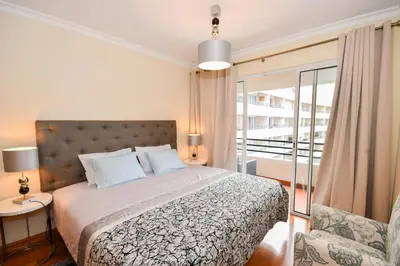 a bedroom with a bed and a balcony at M Palace II in Funchal