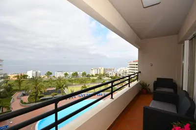 a balcony with a view of the beach at M Palace II in Funchal