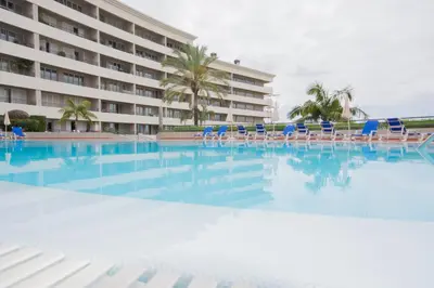 a swimming pool with chairs and a hotel at M Palace II in Funchal