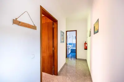 a hallway with a door and a sign on a wall at Local Guesthouse in Sagres