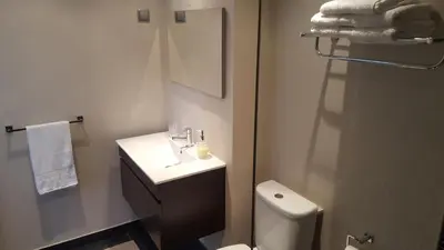 a bathroom with a sink and a toilet and a mirror at Apartamento Funchal com vista Mar in Funchal