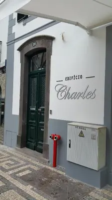a red fire hydrant in front of a building at Edificio Charles 201 in Funchal