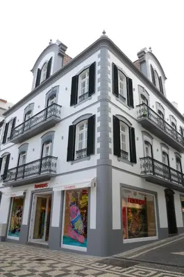 a large white building with black shuttered windows at Edificio Charles 201 in Funchal