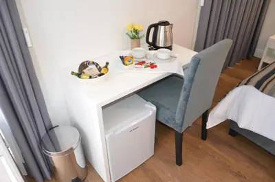 a white desk with a chair and a table at Edificio Charles 201 in Funchal
