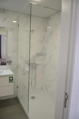 a bathroom with a shower with a glass door at Edificio Charles 201 in Funchal
