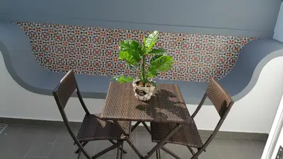 a table and chair with a potted plant on it at Edificio Charles 303 in Funchal