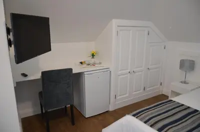 a bedroom with a bed and a desk and a tv at Edificio Charles 303 in Funchal