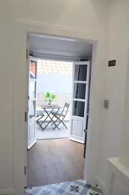 an open door to a patio with a table at Edificio Charles 303 in Funchal