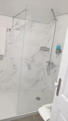 a bathroom with a shower with white marble at Edificio Charles 303 in Funchal