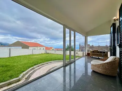 a living room with a large glass window at Villa Passion by AnaLodges in Funchal