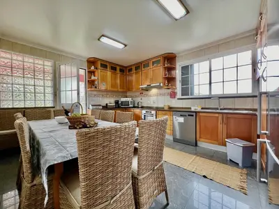 a kitchen with a table and some chairs in it at Villa Passion by AnaLodges in Funchal