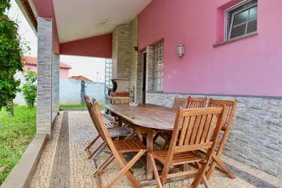 a wooden table and chairs on a patio at Villa Passion by AnaLodges in Funchal