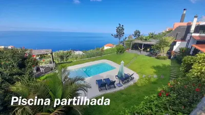 a villa with a swimming pool and the ocean at Casa Velha D Fernando e Casa Avó Augusta in Ribeira Brava