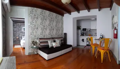 a living room with a couch and a table at Casa Velha D Fernando e Casa Avó Augusta in Ribeira Brava