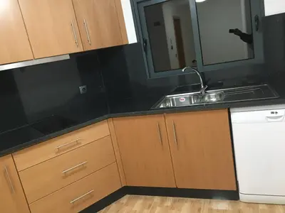 a kitchen with a sink and a mirror at Vila do Rocha in Calheta