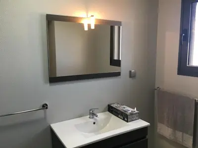 a bathroom with a sink and a mirror at Vila do Rocha in Calheta