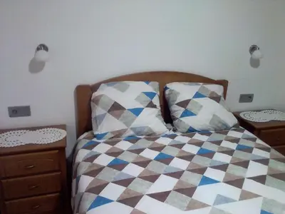 a bedroom with a bed and two pillows on it at Vila do Rocha in Calheta