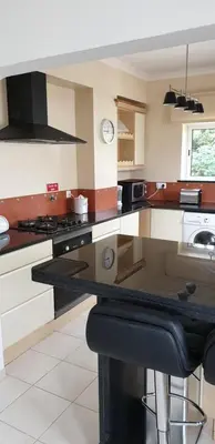 a kitchen with a black counter top in a room at CASA MONACO vue mer in Luz