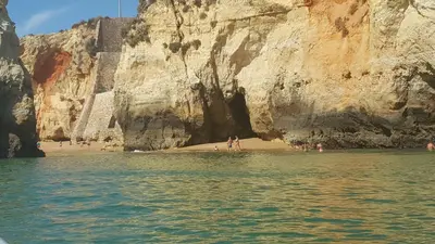 a group of people on a beach next to a cliff at CASA MONACO vue mer in Luz
