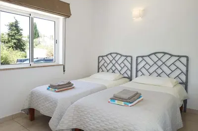 two beds in a room with two windows at CASA MONACO vue mer in Luz