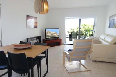 a living room with a dining table and a living room at CASA MONACO vue mer in Luz