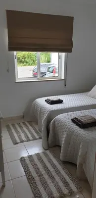 two beds in a room with a window at CASA MONACO vue mer in Luz