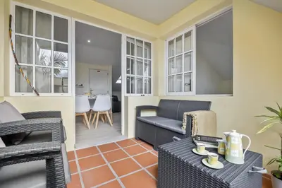 a living room with chairs and a table at Eyes in the Sky in Funchal
