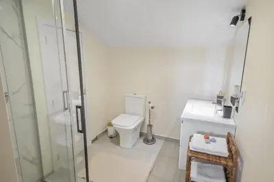 a bathroom with a shower and a toilet and a sink at Eyes in the Sky in Funchal