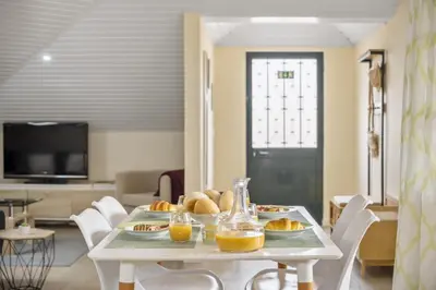 a table with bread and orange juice on it at Eyes in the Sky in Funchal