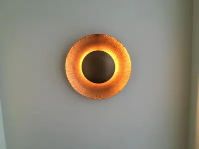 a orange mirror hanging on a wall at Vila Luis Mendes in Ribeira Brava
