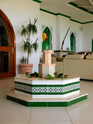 a table with two chairs and a table with a plate of food at Villa Esmeralda in Lagos